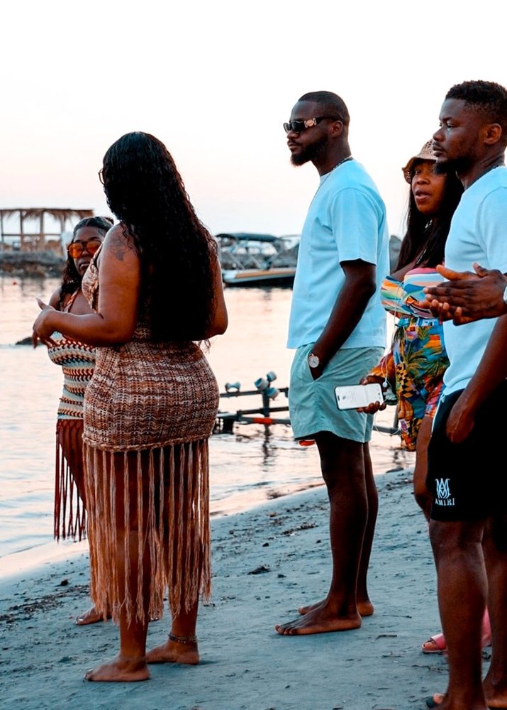 Guests gathered on the beach at sunset