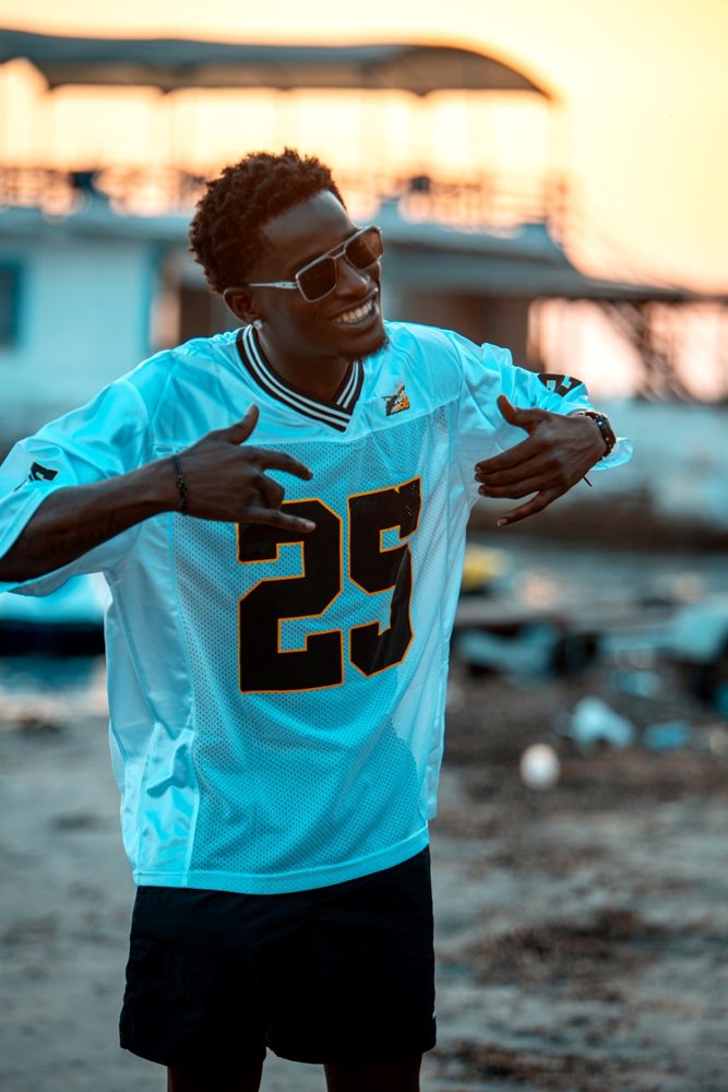 Smiling guest in a JetOut number 25 jersey at sunset
